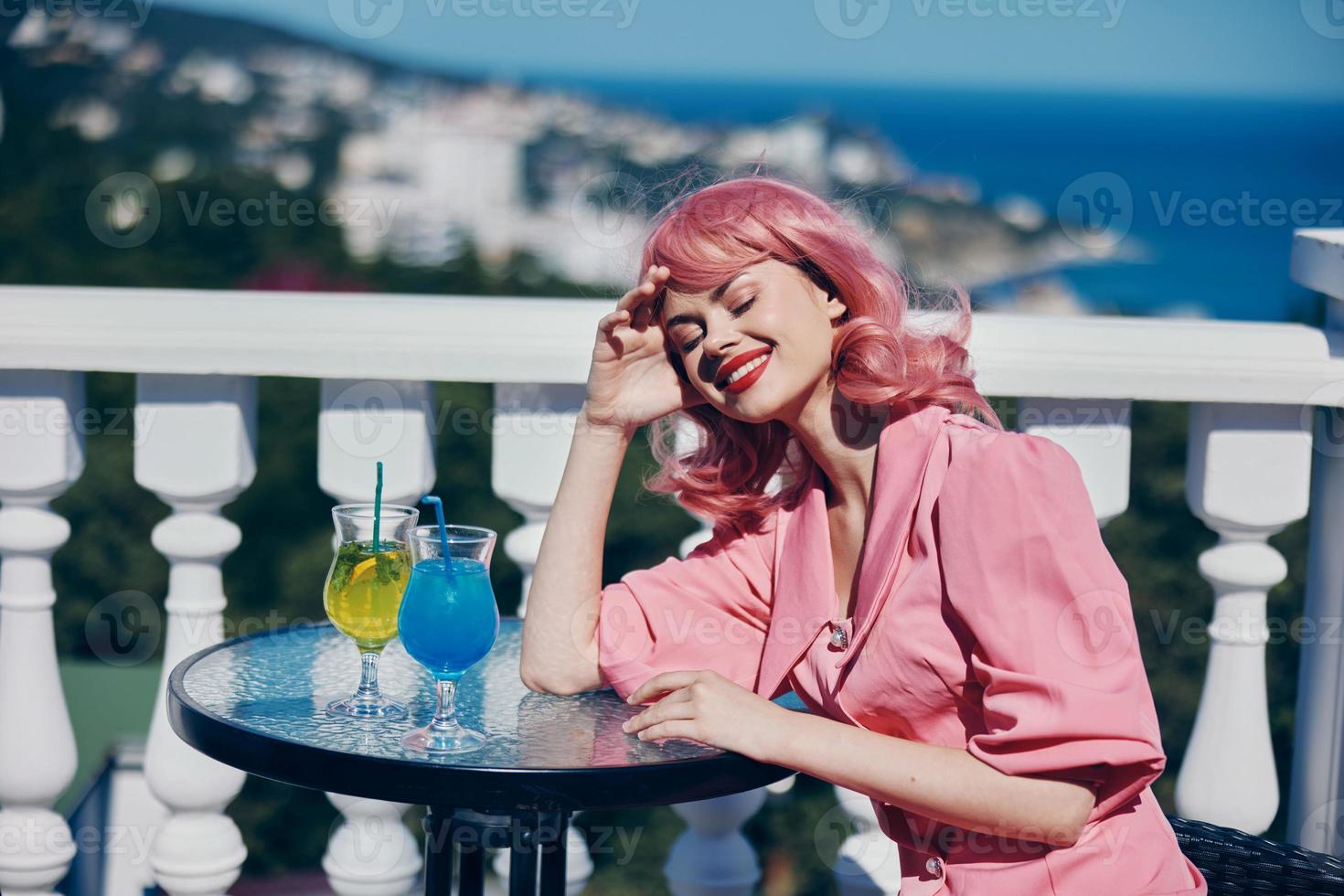 glamorous woman sit at the table with a cocktail Relaxation concept photo