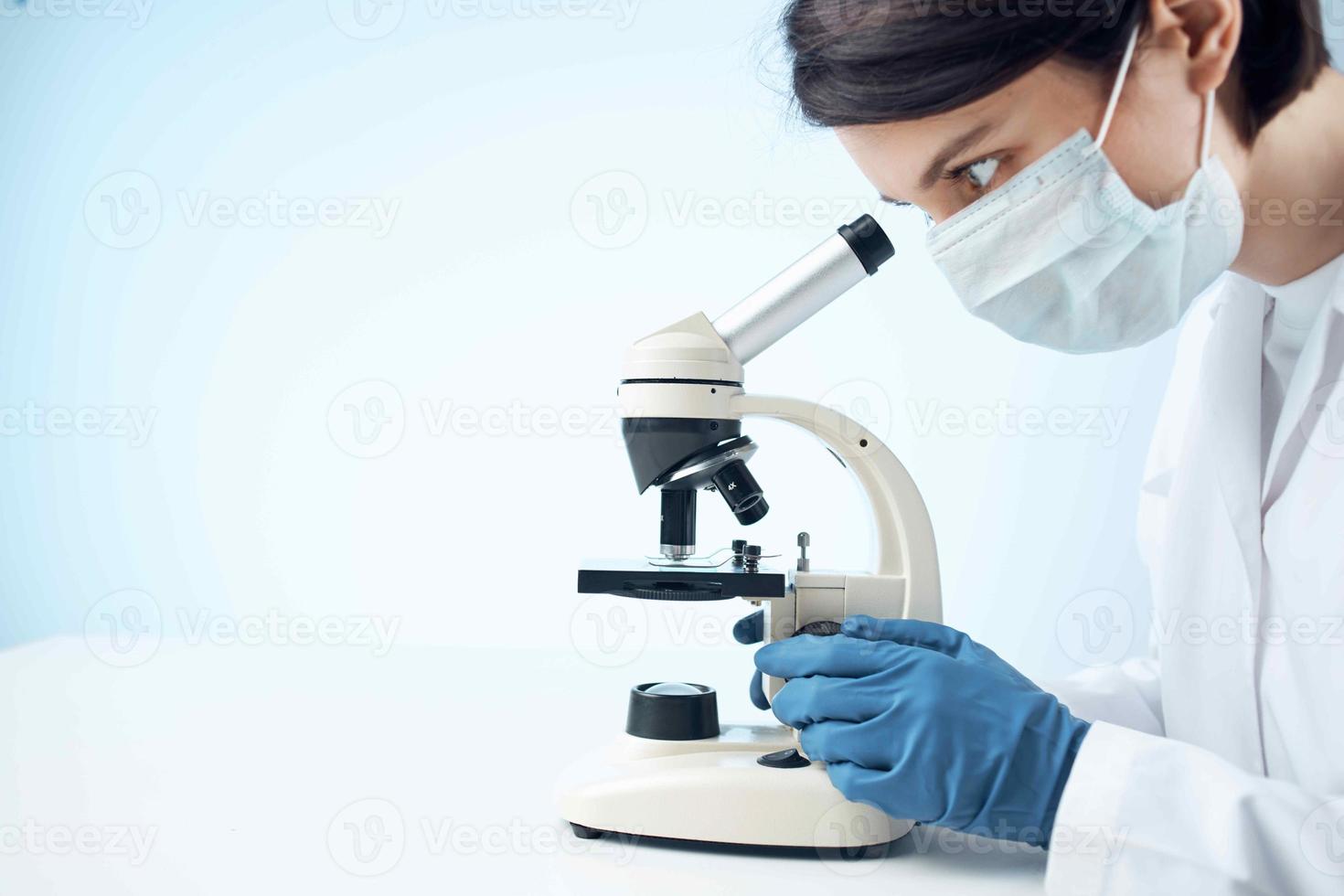 woman laboratory assistant medical mask microscope diagnostics biotechnology photo