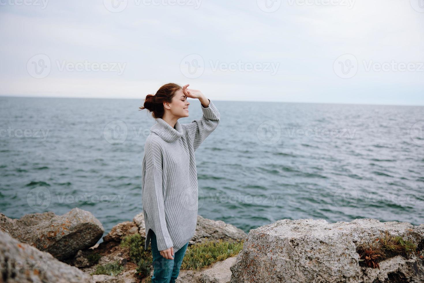 beautiful woman sweaters cloudy sea admiring nature female relaxing photo