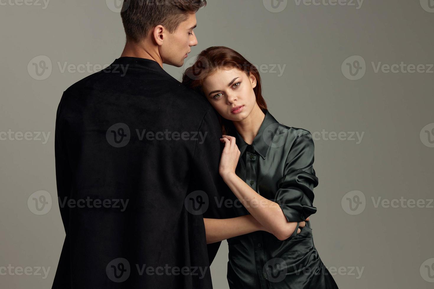 Rear view of a man in a suit and an attractive woman in an evening dress photo