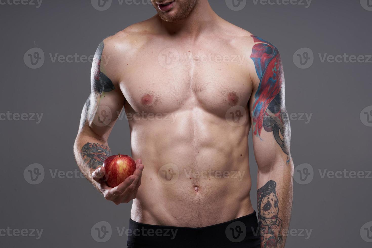 athletic men bodybuilding fitness press pumped up arm muscles tattoo red apple photo