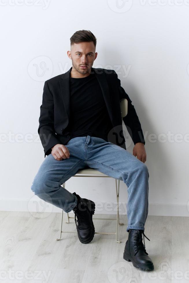 Modelling snapshots. Serious narcissistic self-confident attractive handsome man in classic suit sit on chair posing isolated in white studio background. Fashion offer. Copy space for ad photo