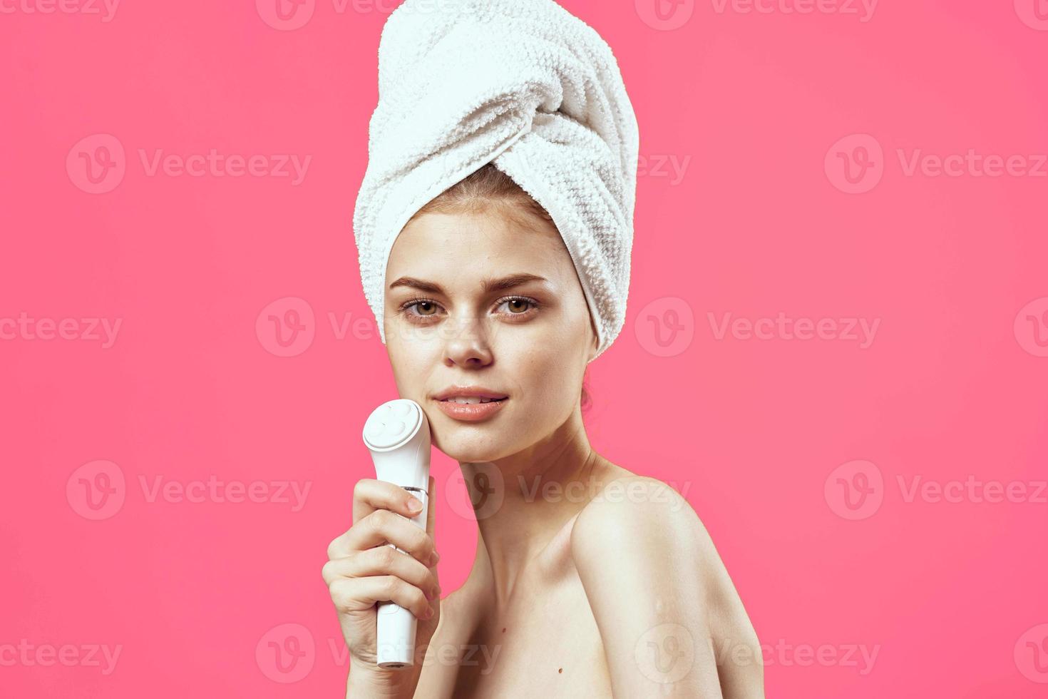 woman with towel on head naked shoulders massager health dermatology photo