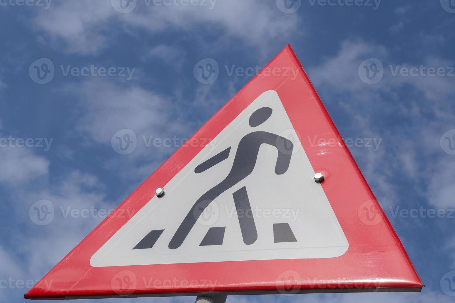 road sign pedestrian crossing against blue sky photo