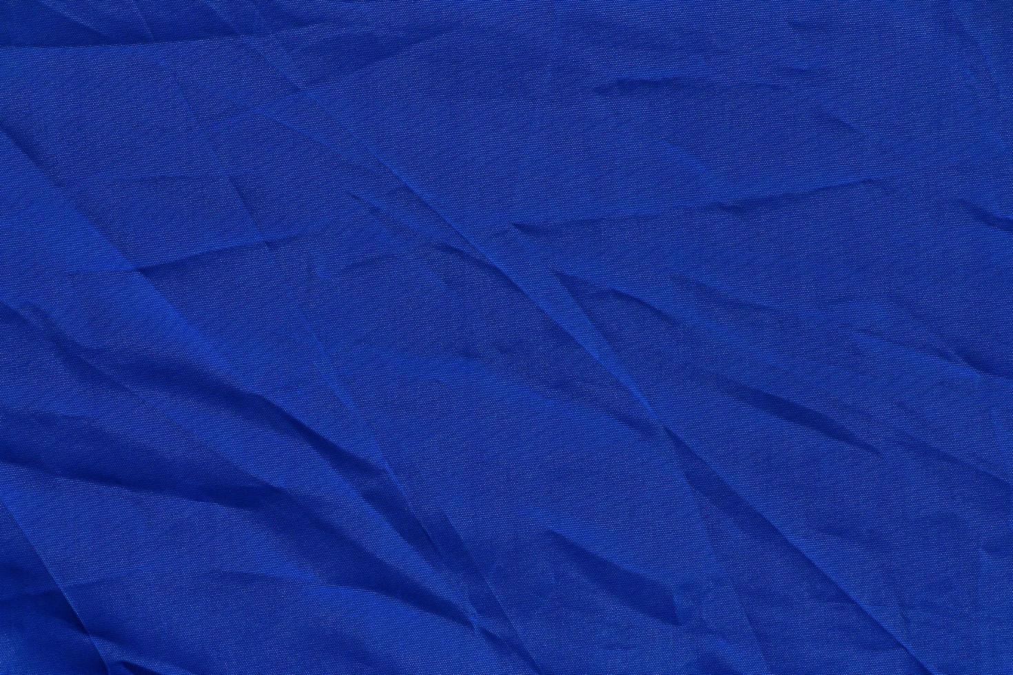 close up of dark blue crumpled fabric texture photo