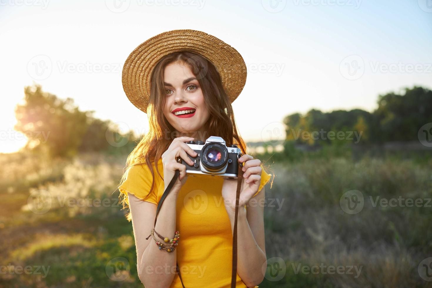 pretty woman holding camera in hands nature fresh air lifestyle photo