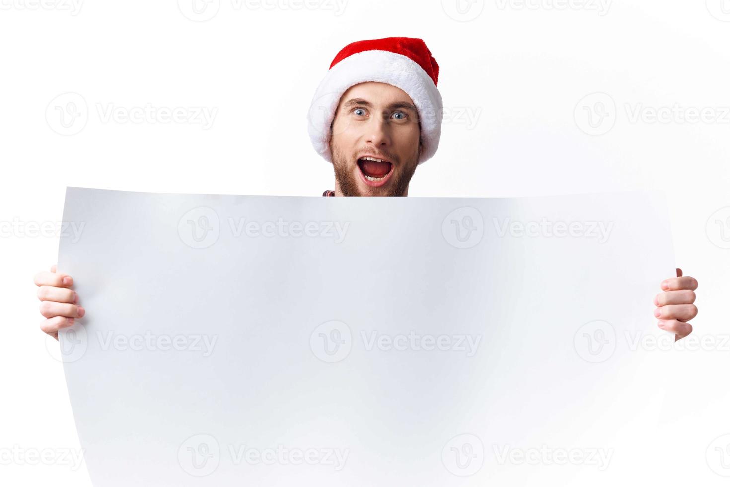 handsome man in a christmas hat with white mockup poster christmas copy-space studio photo