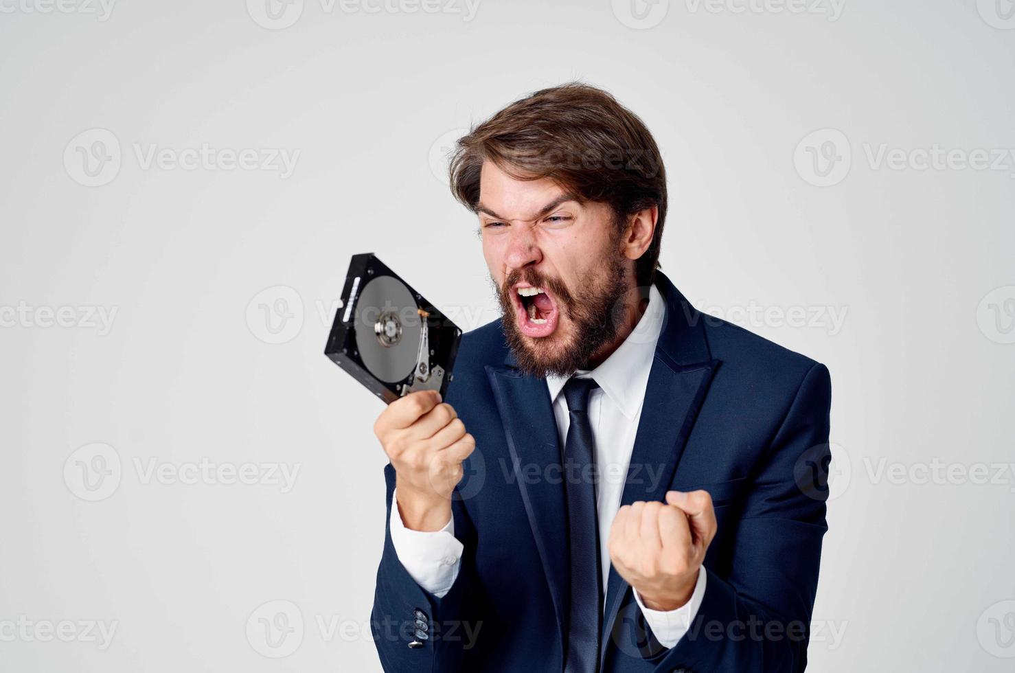 a man in a suit with a hard drive information recovery emotions photo