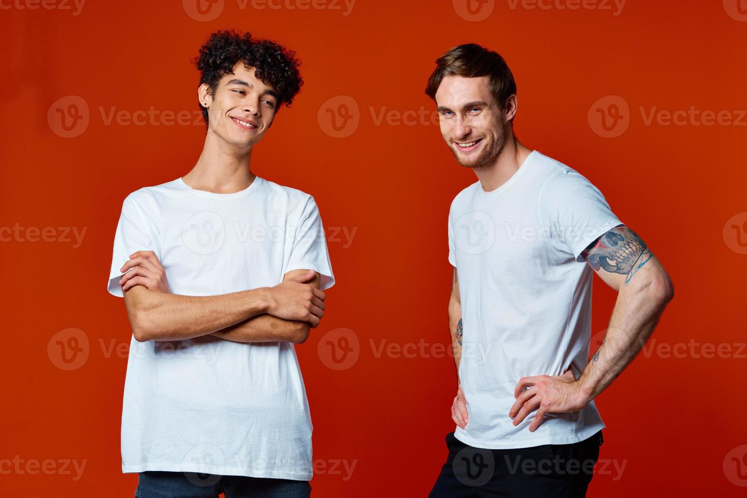 funny two men in white t-shirts on a red background friendship photo