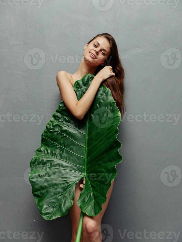 woman charming look big green leaf cover naked body photo