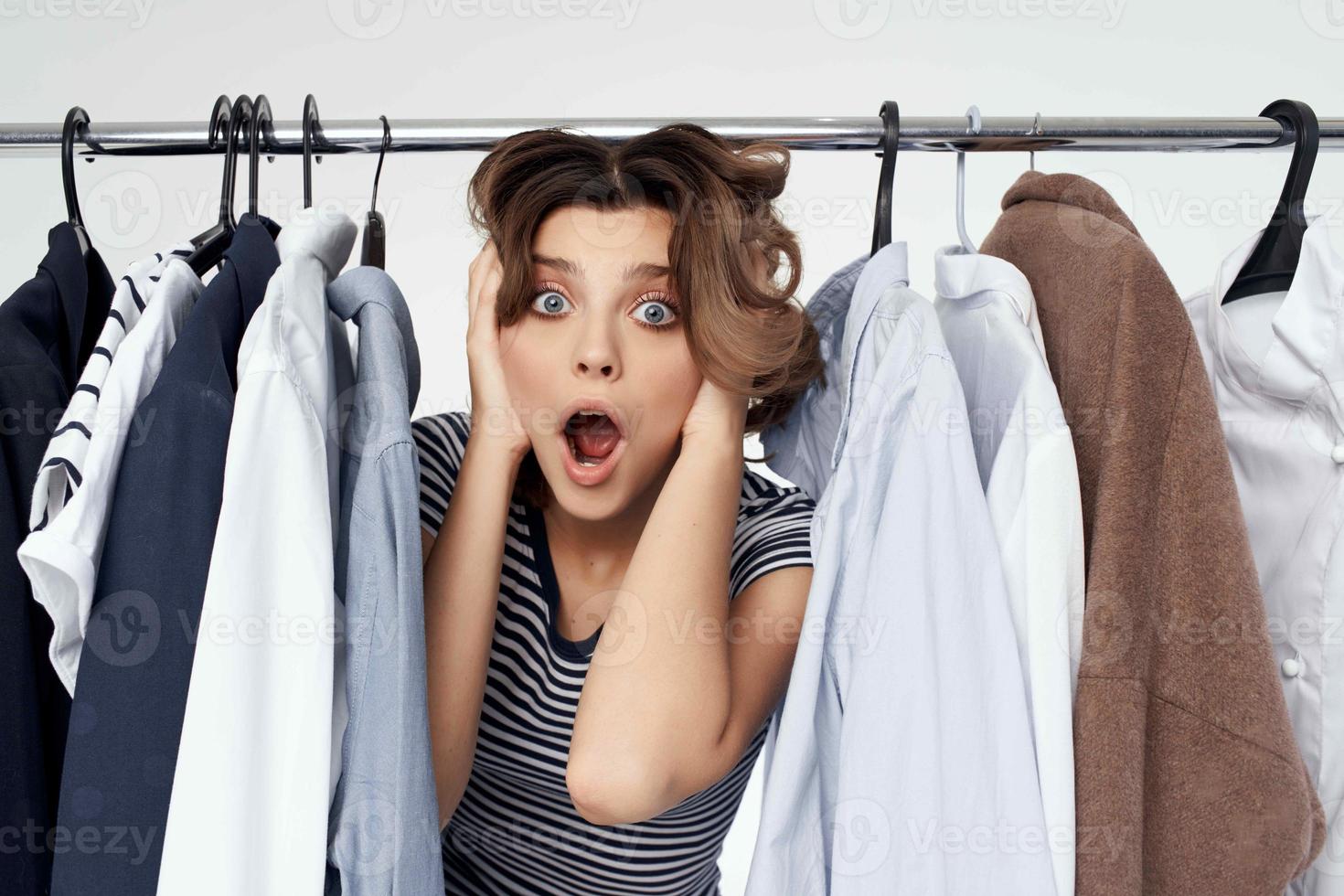 beautiful woman trying on clothes shop retail light background photo