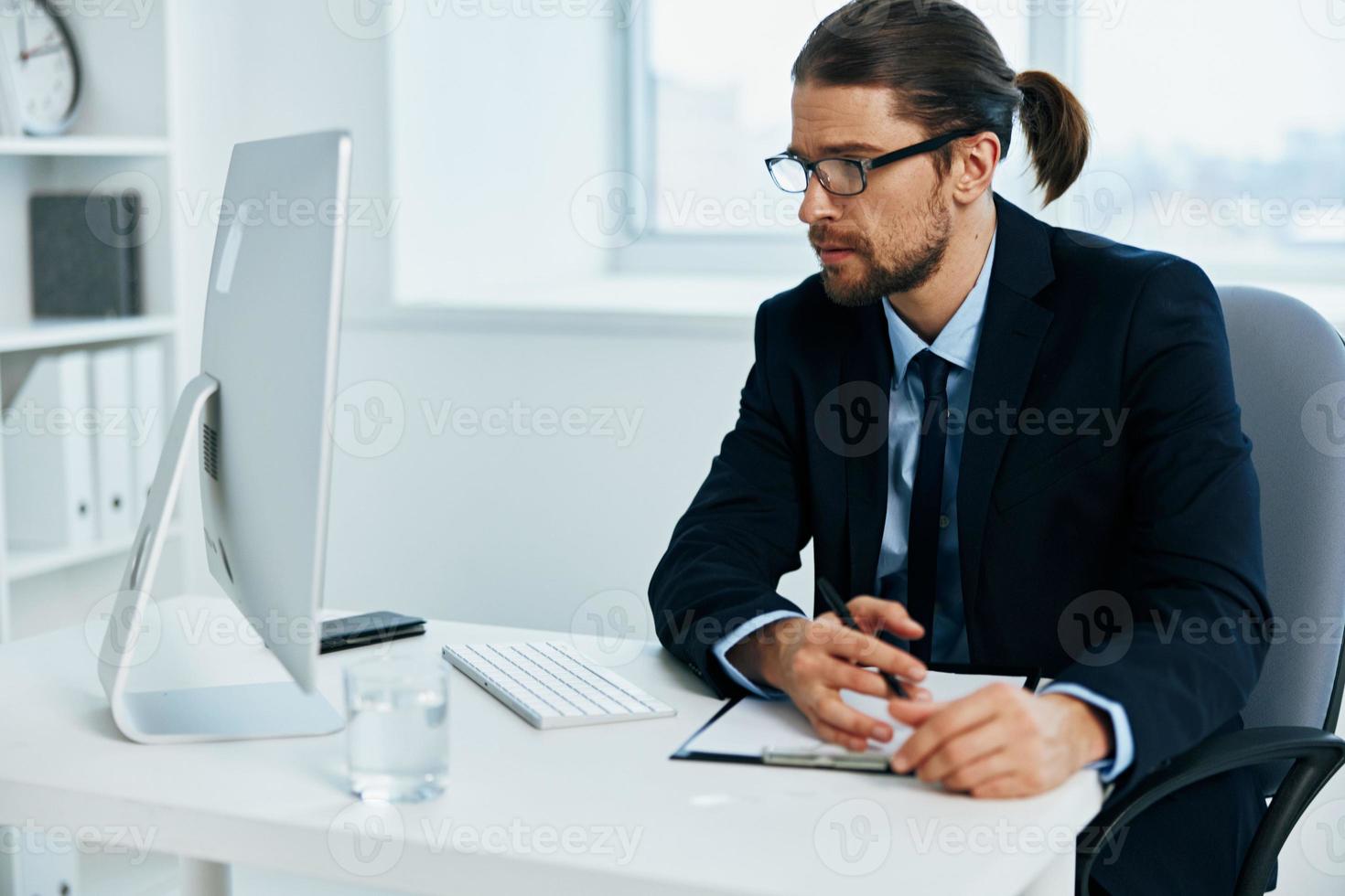 office worker sitting at a desk in front of a computer Lifestyle photo