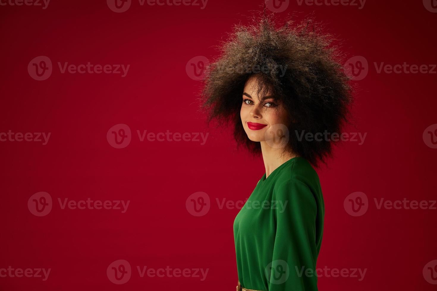 pretty woman in green dress afro hairstyle studio photo