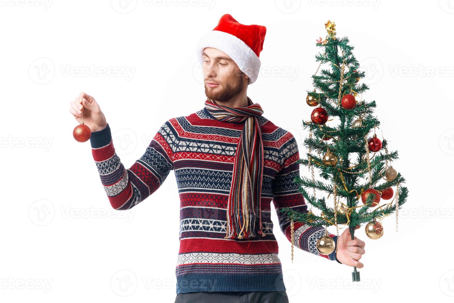 Cheerful man in New Year's clothes decoration christmas studio posing photo