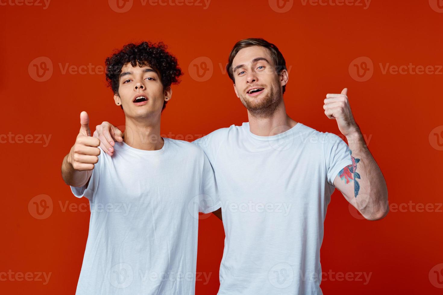 two man in white t-shirts fun emotions hand gestures friendship hugs photo