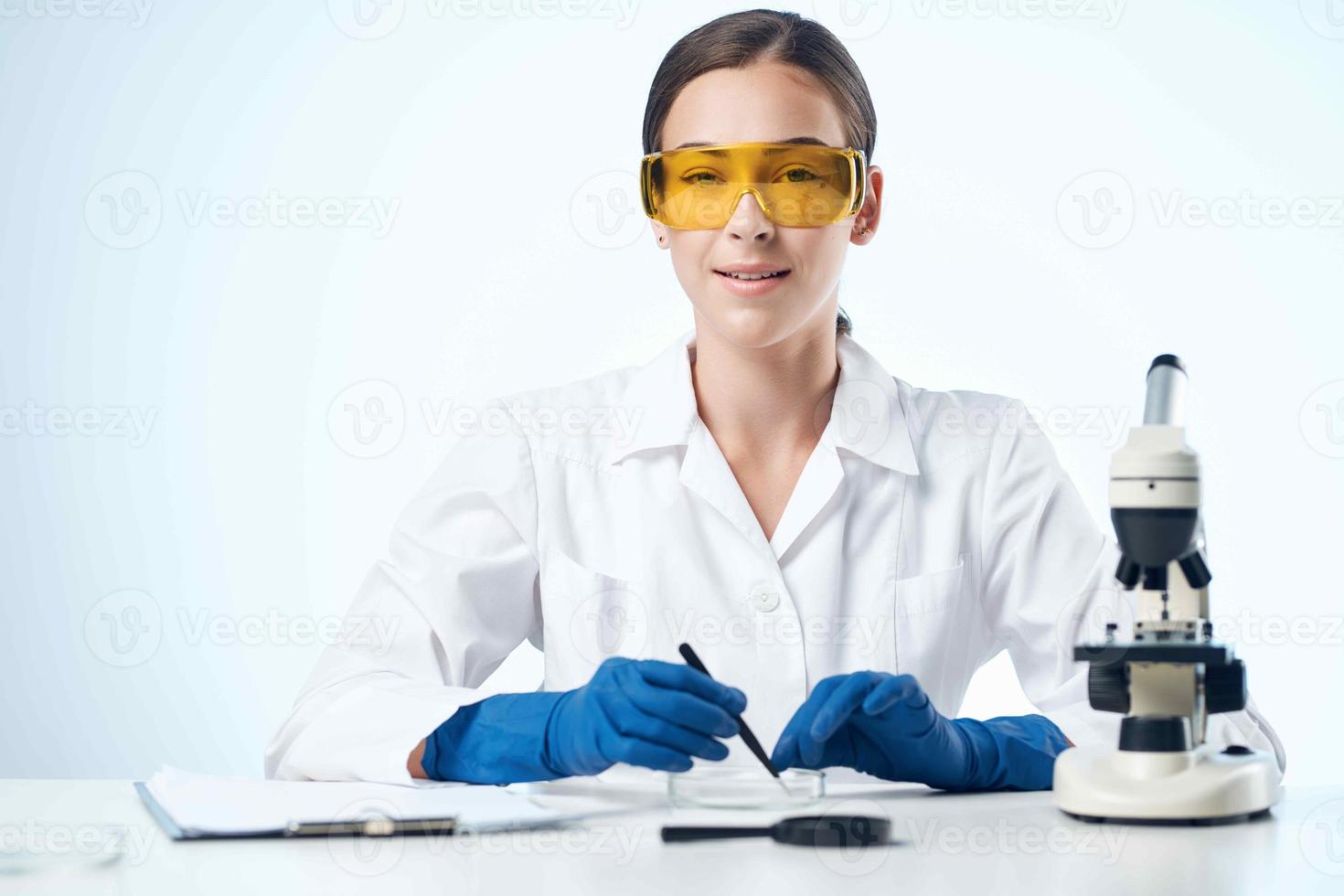 woman with microscope in laboratory research scientists photo