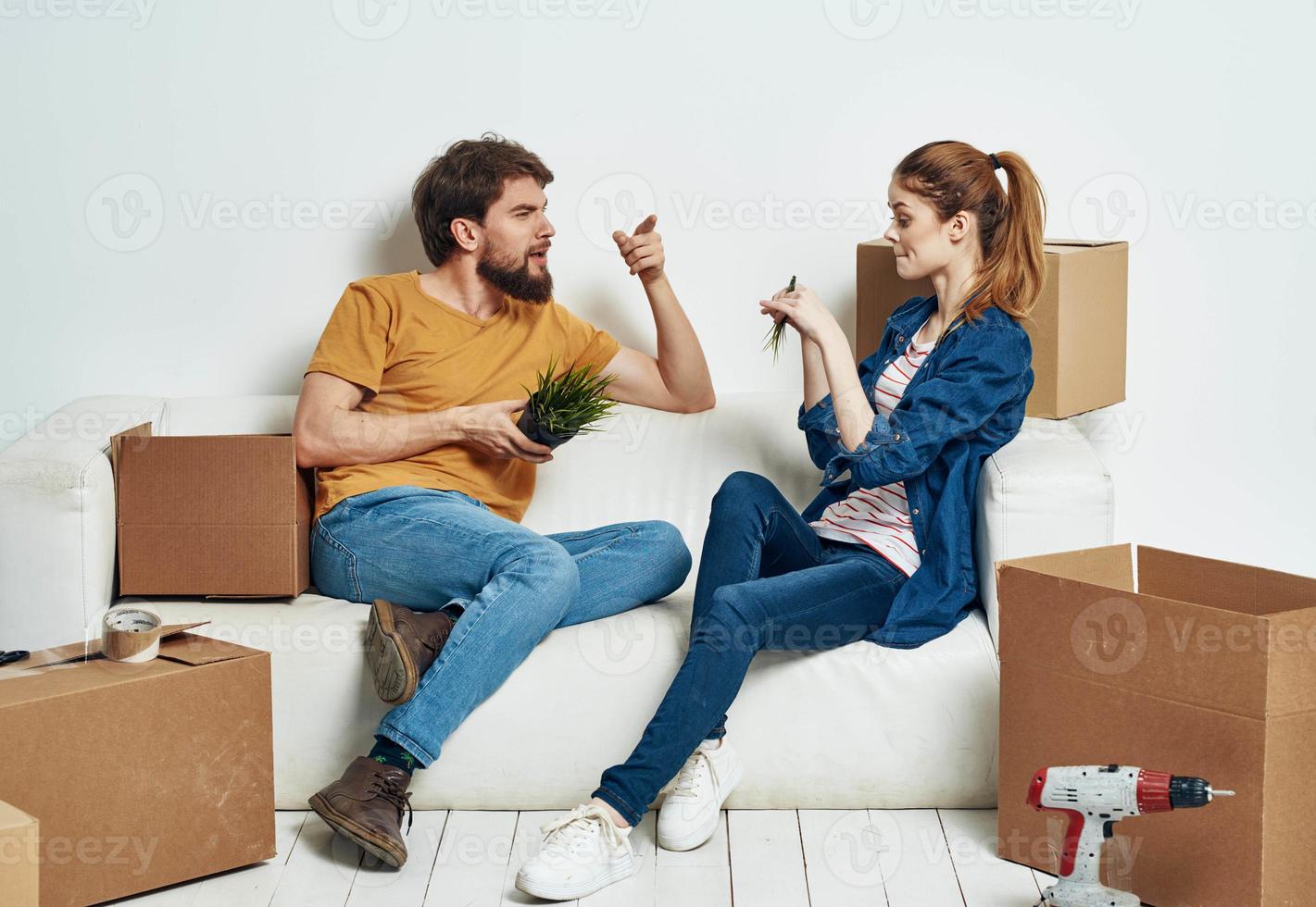 Cheerful young couple in an apartment boxes with things moving photo
