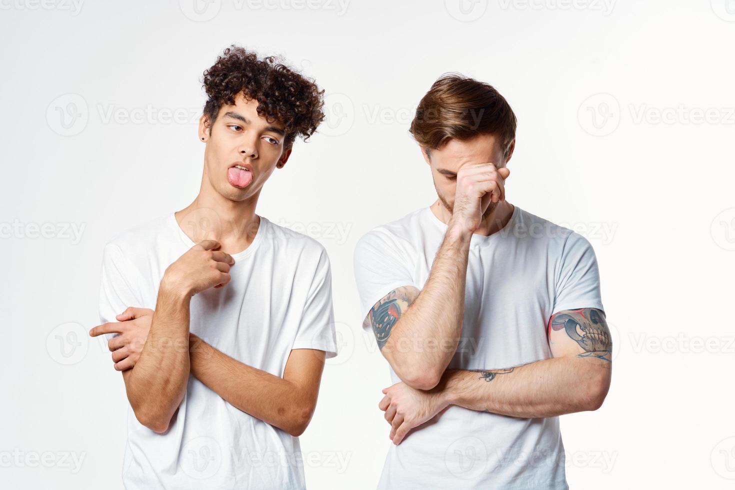 two guys in white t-shirts next to friendship communication emotions photo