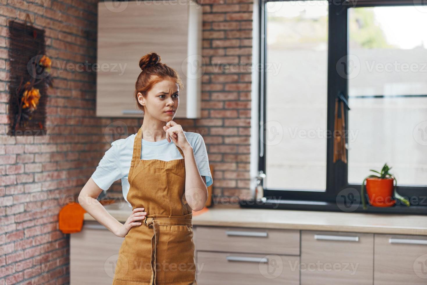 woman houses in the kitchen gestures with his hands apartments household concept photo