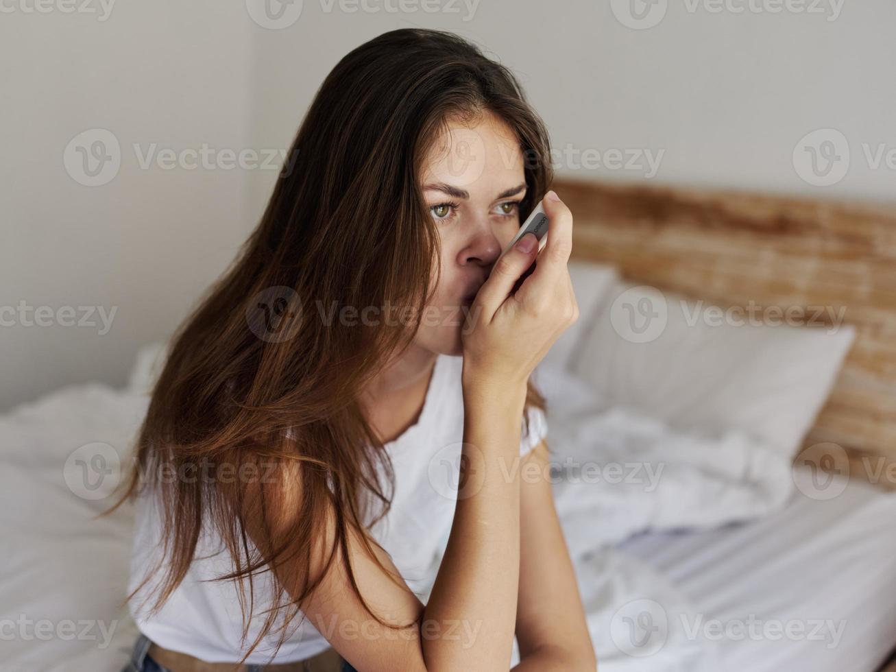 woman in bedroom at hotel keep thermometer in mouth measuring