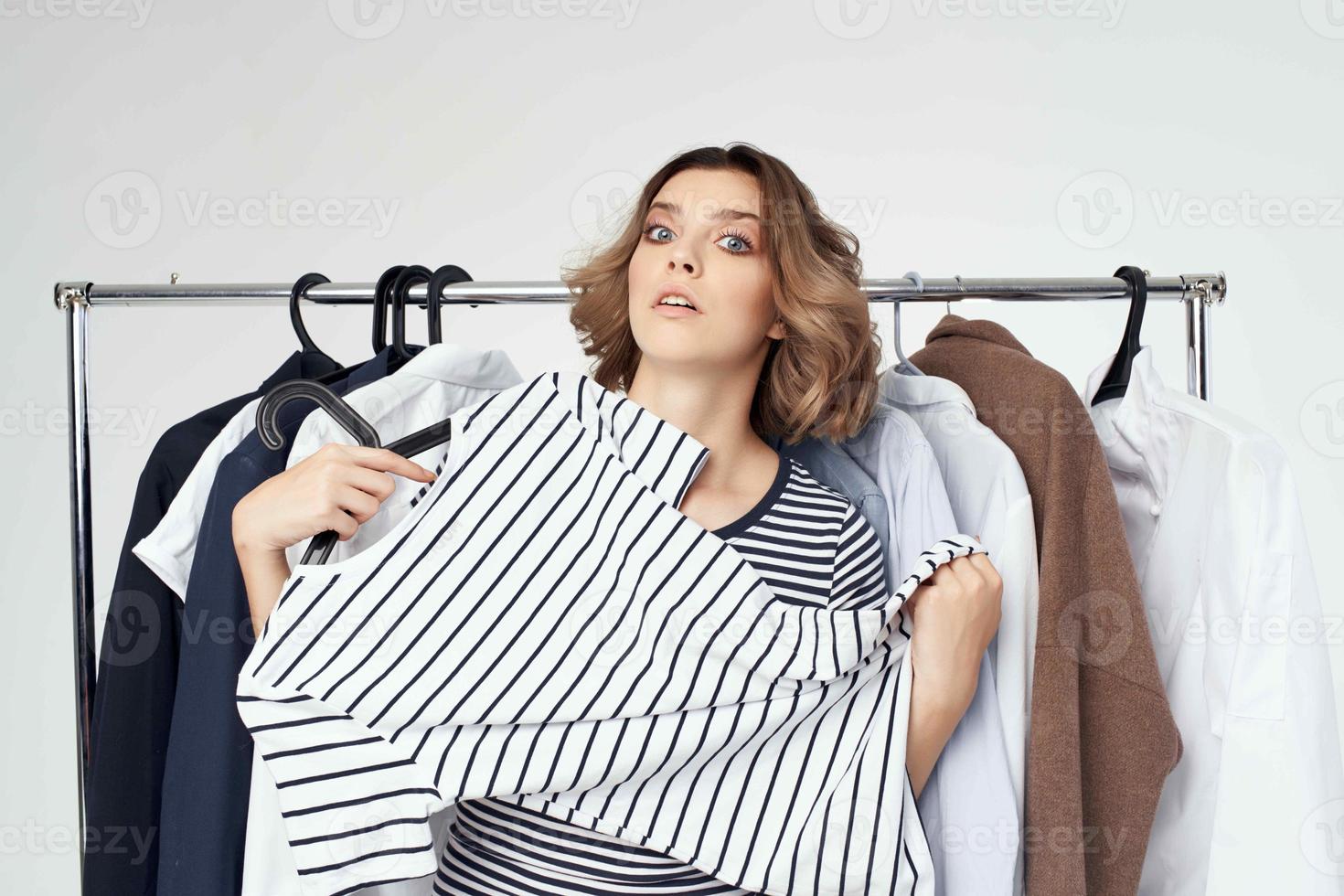 beautiful woman trying on clothes isolated background photo