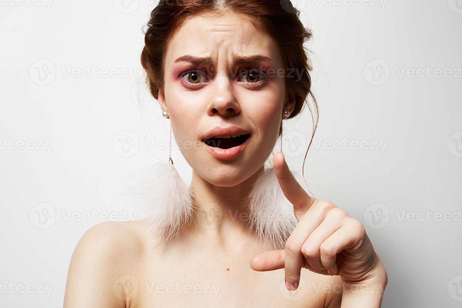 pretty woman with bare shoulders jewelry fashion posing photo