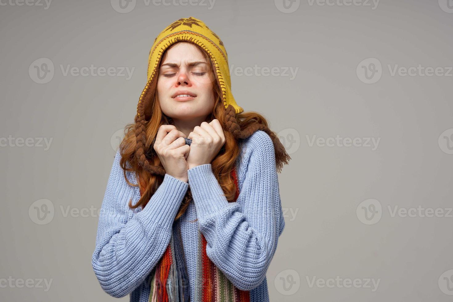 sick woman neck scarf with a hat on his head light background photo