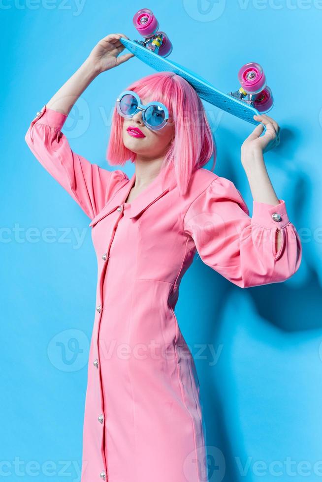 glamorous woman in sunglasses wears a pink wig studio model unaltered photo