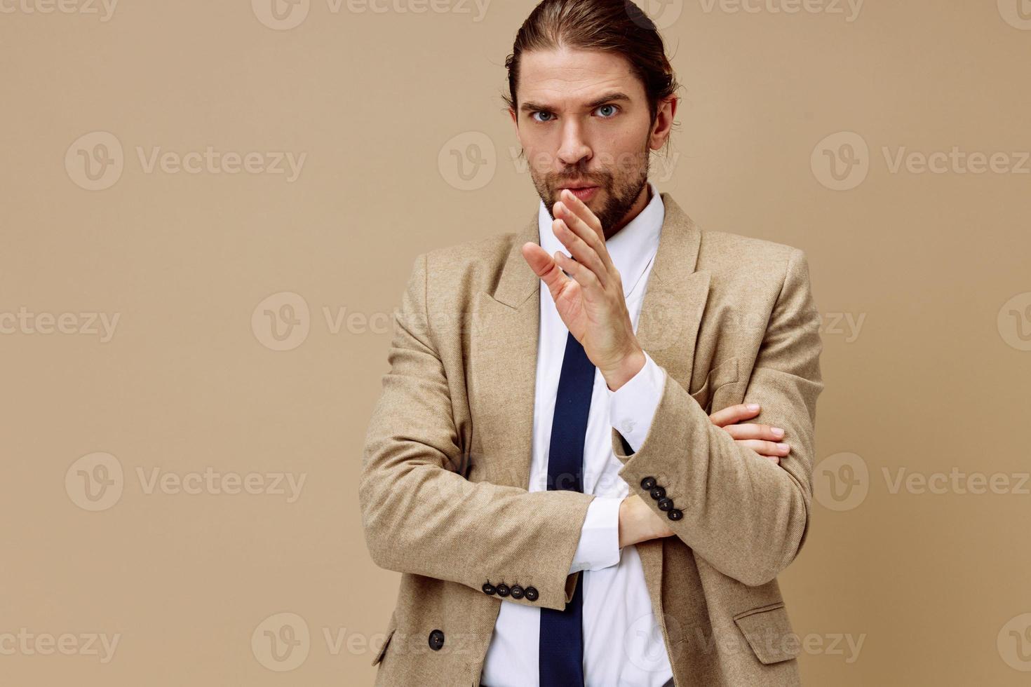 fashionable man emotional man in suit gesture with hands beige background photo