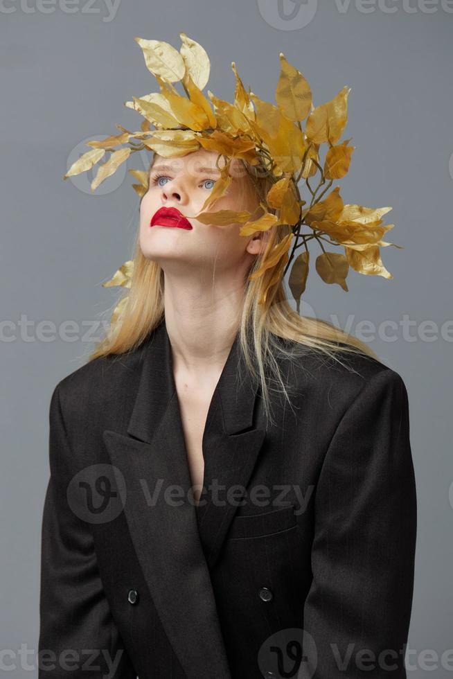 portrait of a woman golden leaves wreath black blazer red lips isolated background photo