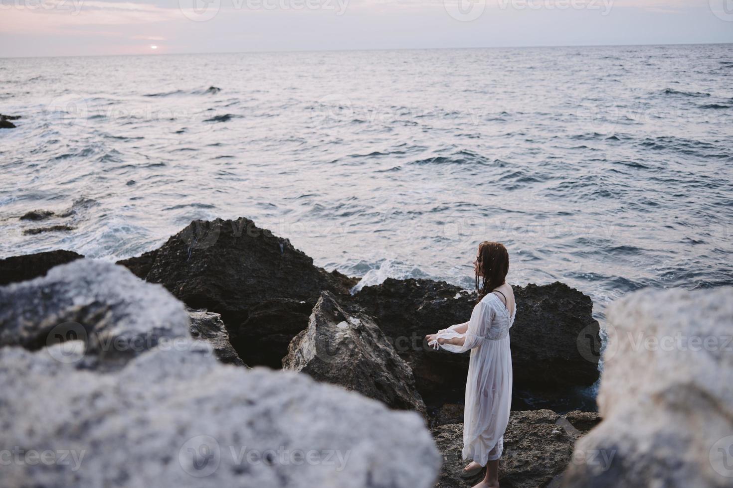 woman traveler enjoying for view of the beautiful sea on her holiday freedom photo