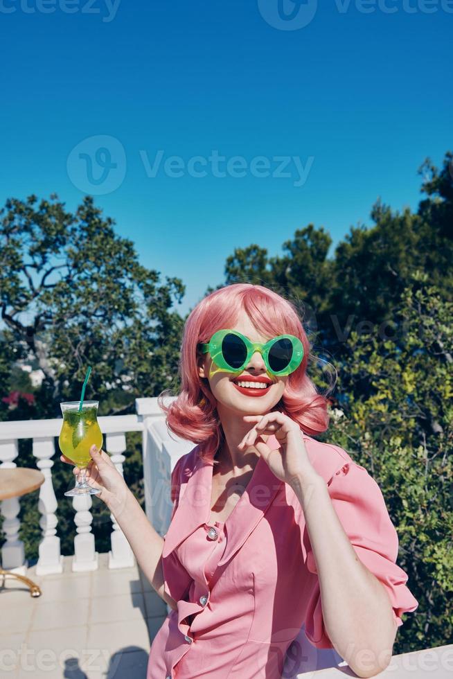 portrait of beautiful woman green glasses glamor cocktail fun Happy female relaxing photo
