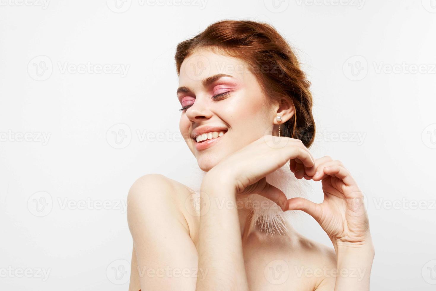 cheerful woman bare shoulders bright makeup fluffy earrings Studio photo
