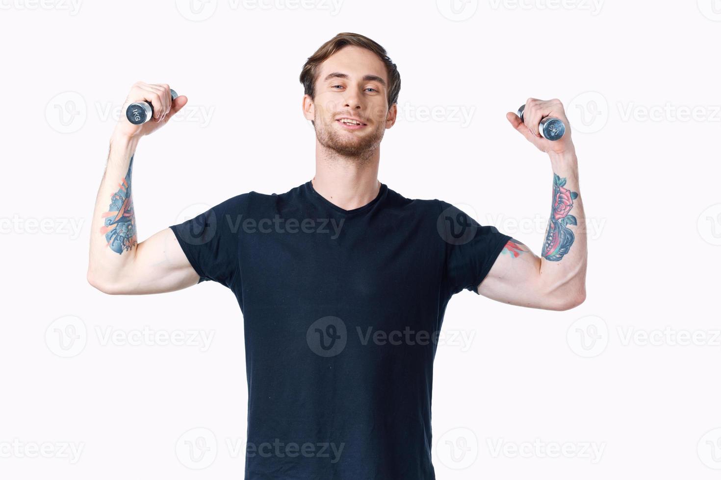 man with dumbbells muscles muscles bodybuilder fitness and tattoo on his arm photo