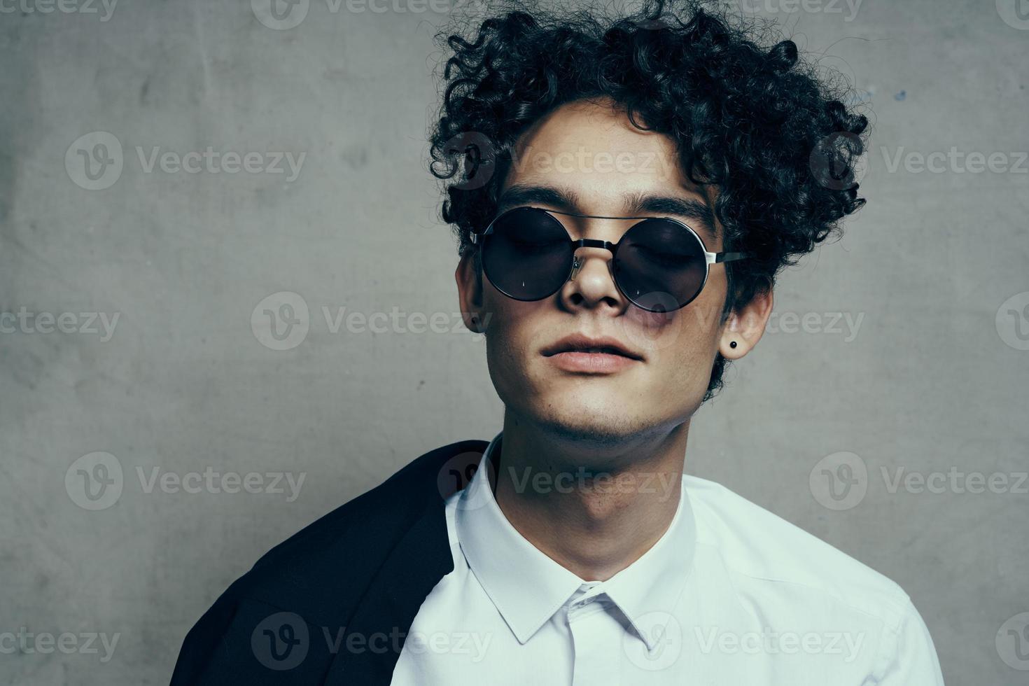 handsome guy model in shirt and glasses jacket on shoulder portrait close-up photo