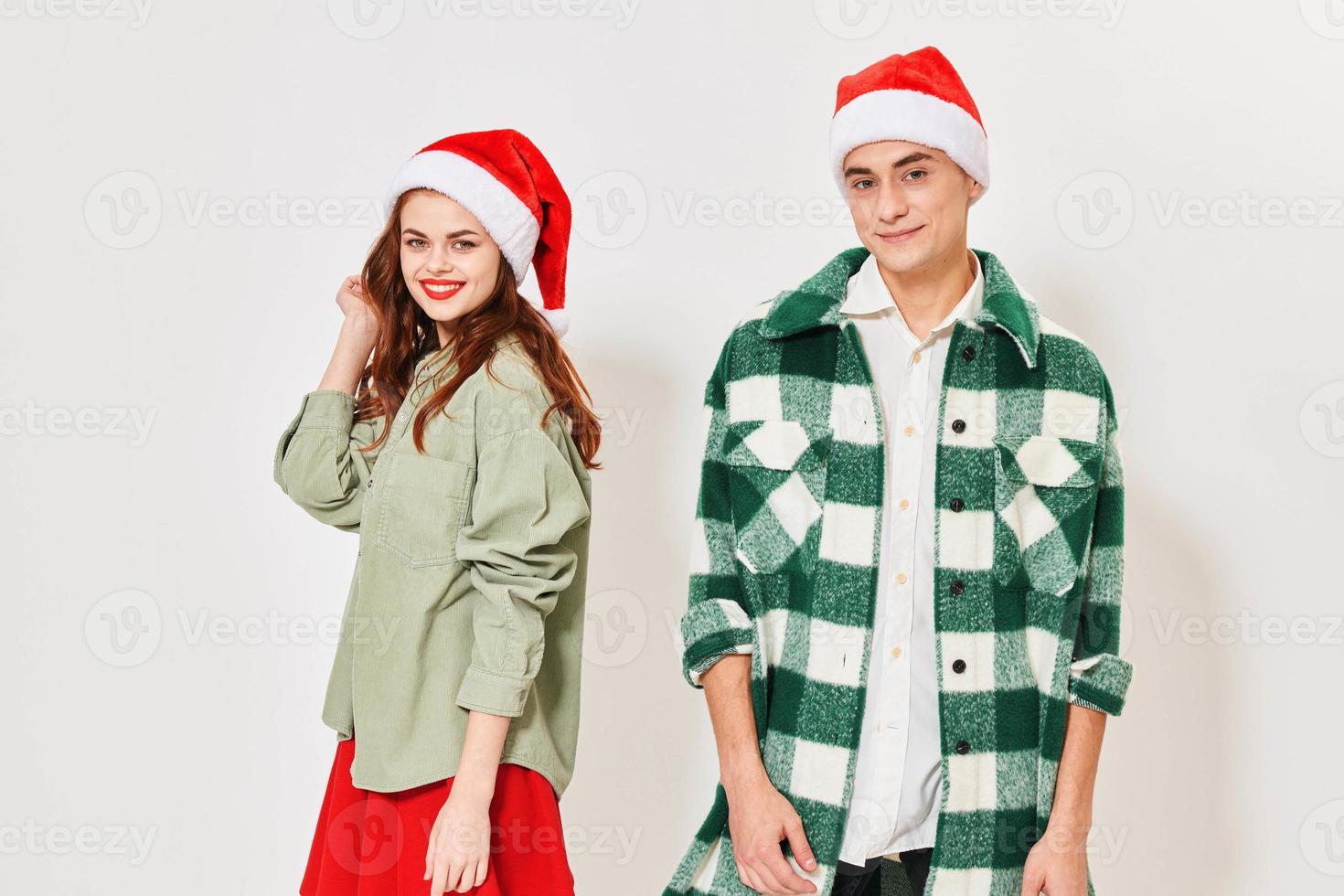 Man and woman in festive caps on a light background cropped view photo