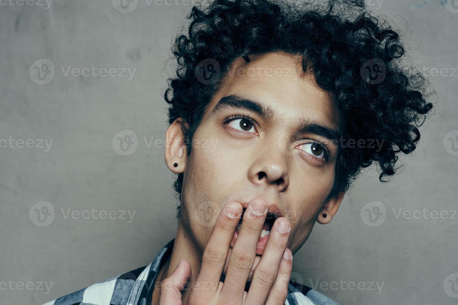 cute guy portrait curly hair emotions gray background model photo