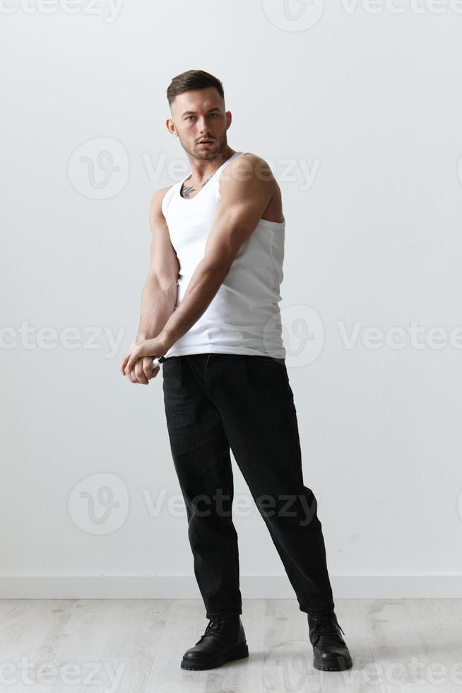 Full body shot of handsome tanned sporty attractive serious man guy posing on white studio background. Fashion Style New Collection Offer. Copy space for ad. Modeling snapshots photo