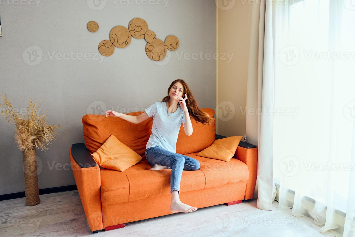 cheerful woman on the couch rest fun Comfort apartments photo