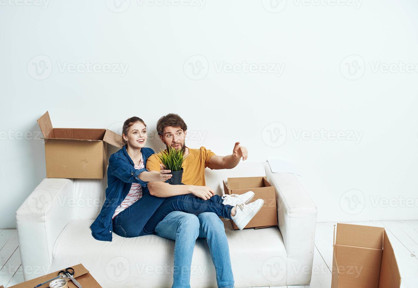 young married couple boxes with things moving room interior fun photo