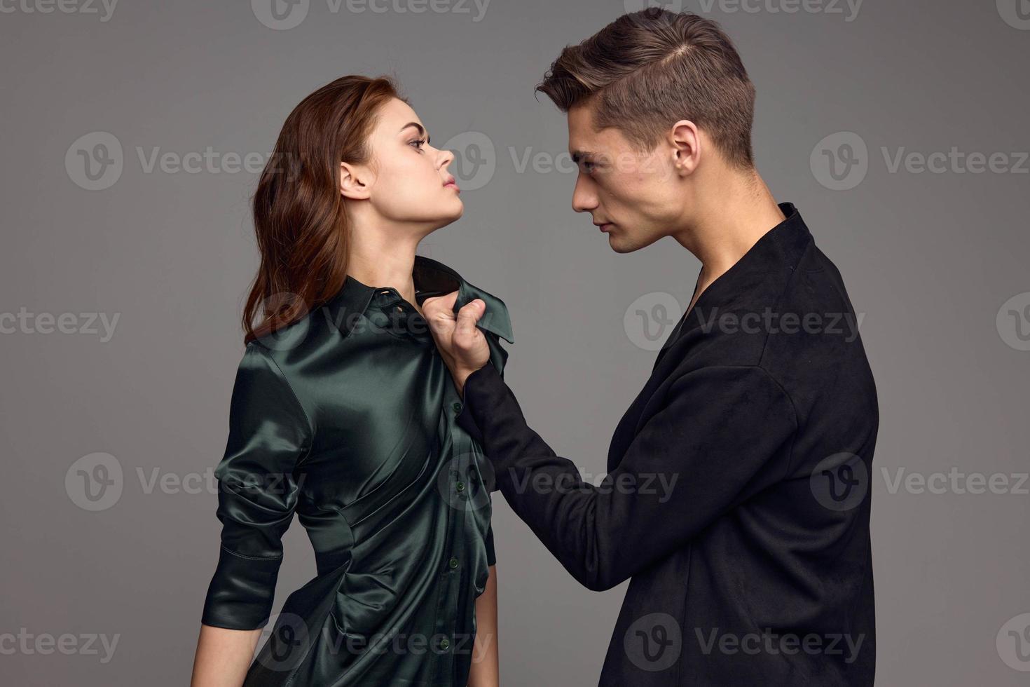 Aggressive man beats up woman on gray background cropped view photo