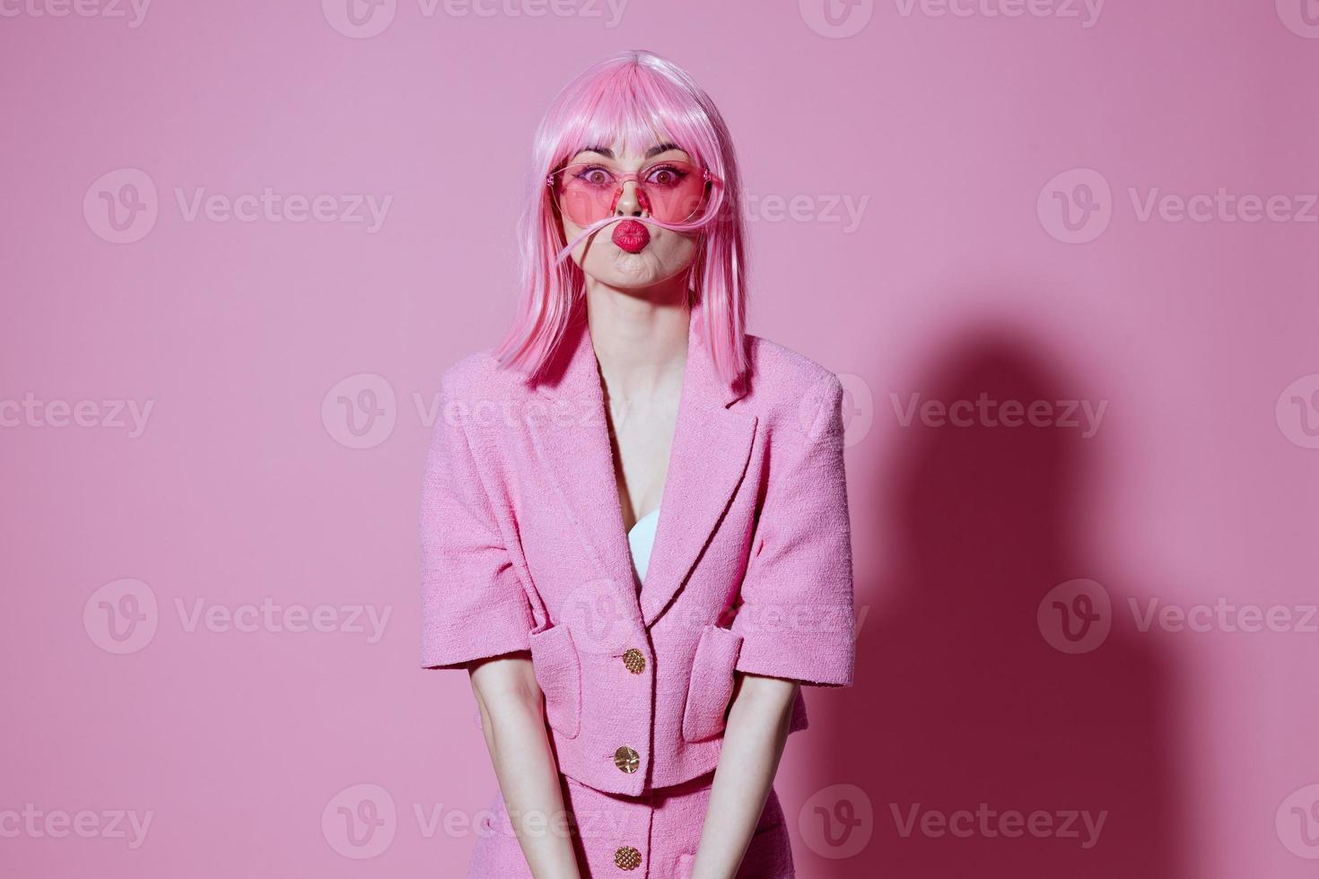 Positive young woman gestures with his hands with a pink jacket Studio Model unaltered photo