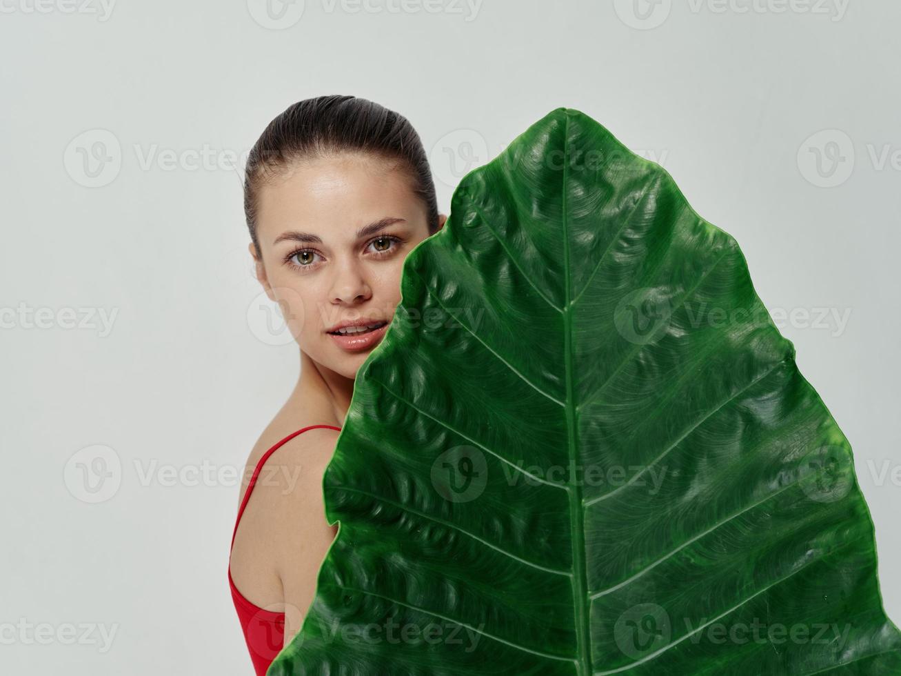 woman holding palm leaf charm cropped view studio photo