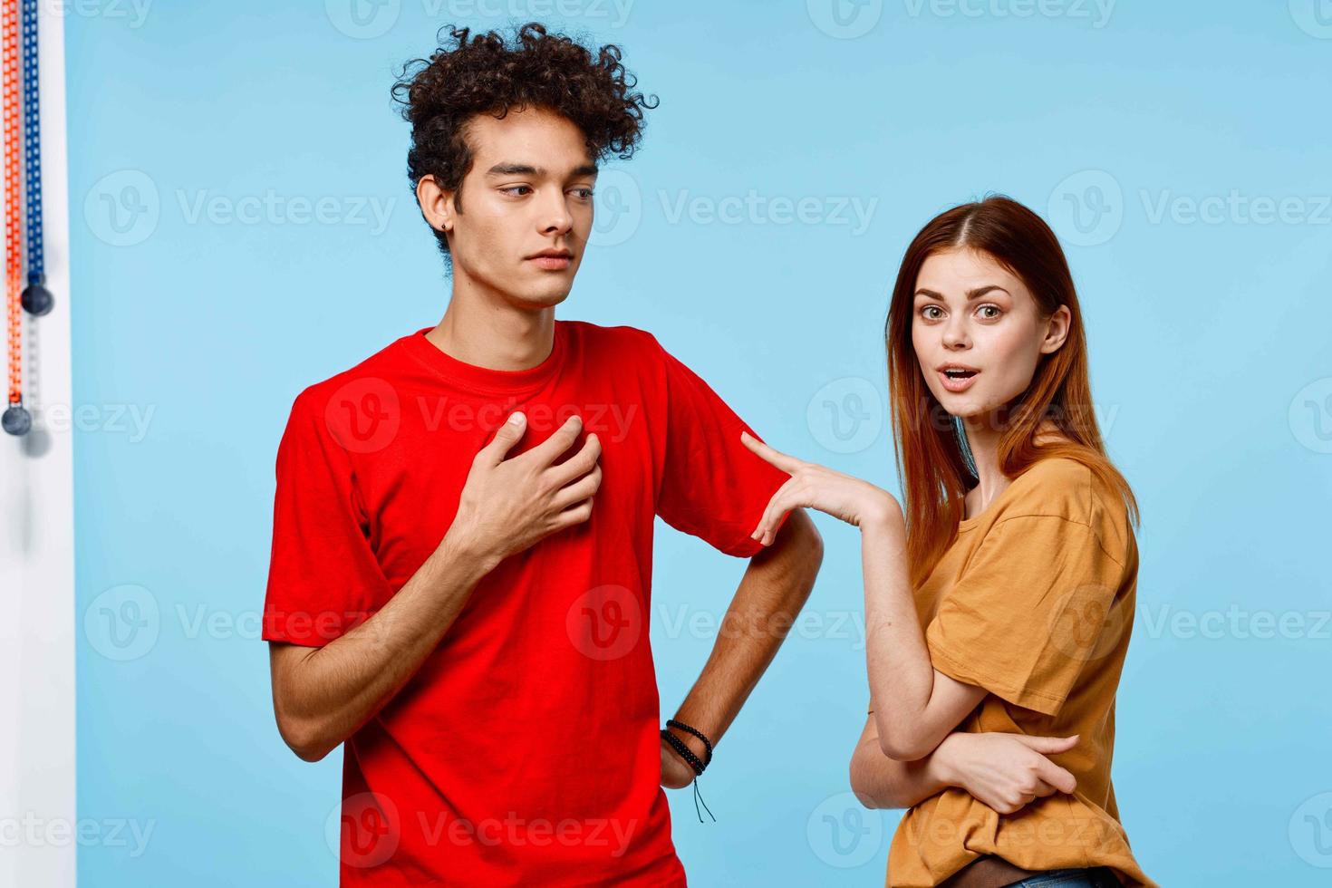 man and woman in colorful t-shirts communication youth style blue background photo