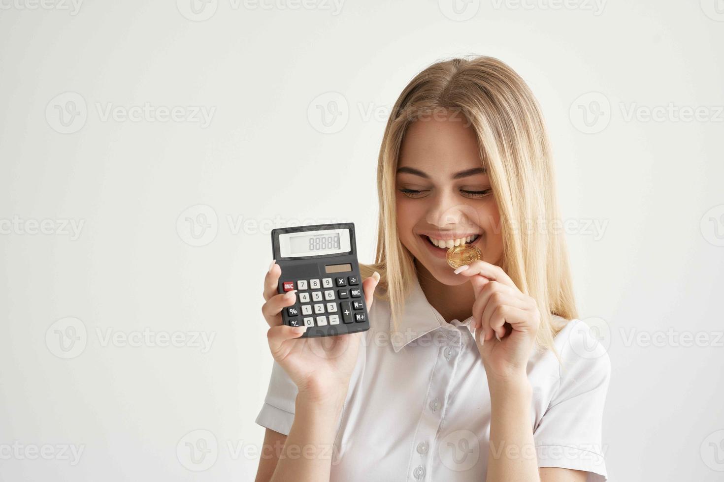 Businesswoman calculator in hand and bitcoin light background photo