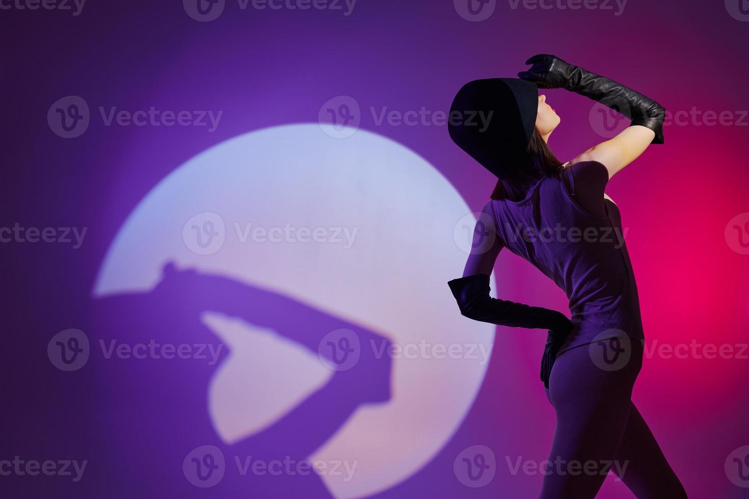 Portrait of a charming lady posing studio light neon color background unaltered photo