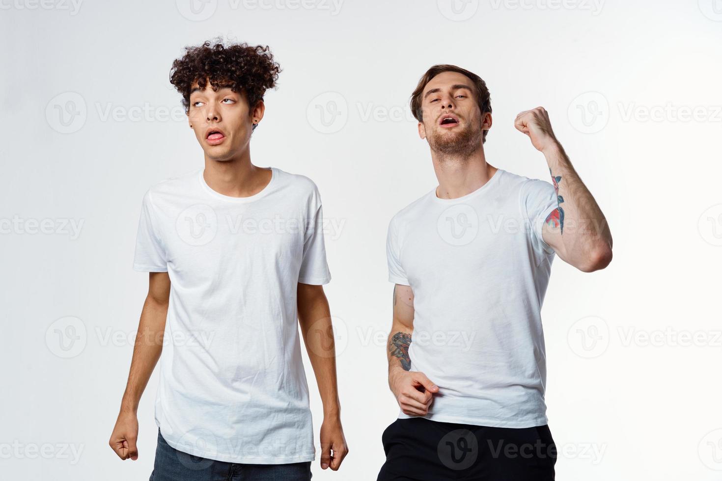 Two cheerful friends in t-shirts emotions lifestyle light background photo