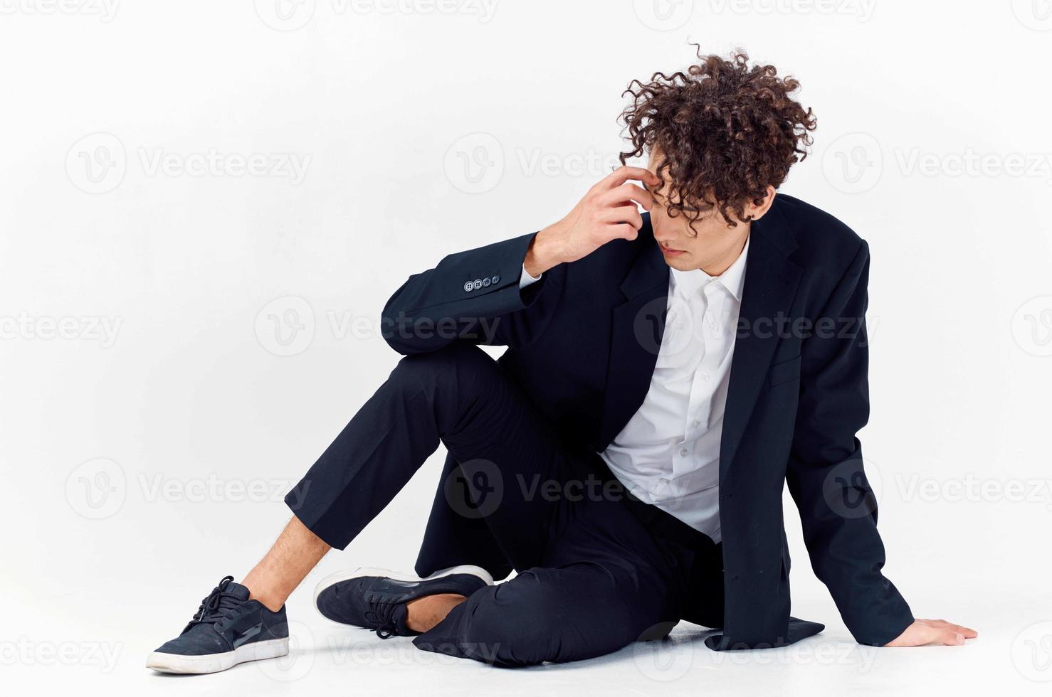 guy in black jacket sitting on the floor fashion elegant style photo