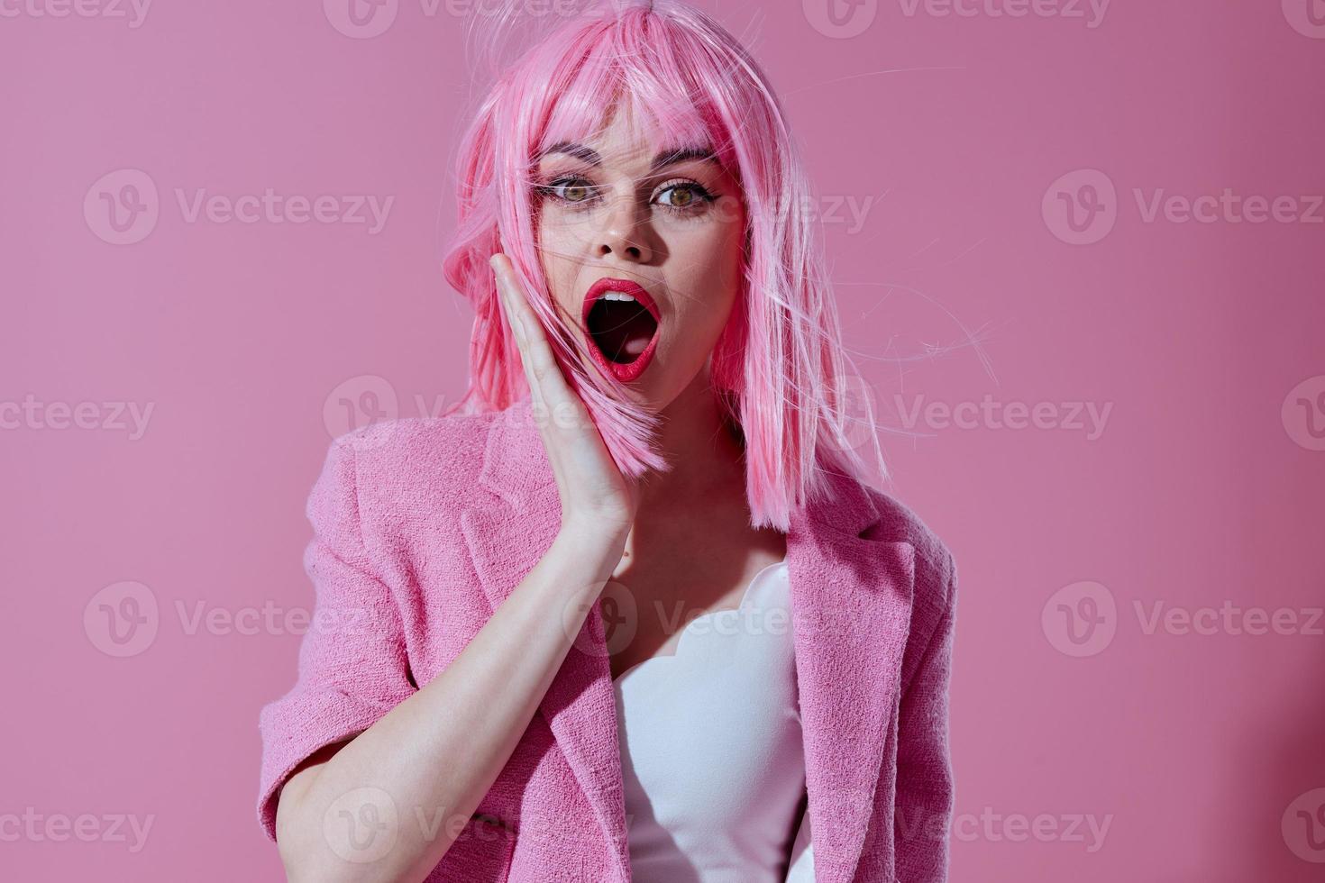 Young woman pink jacket holding hair cosmetics pink background unaltered photo