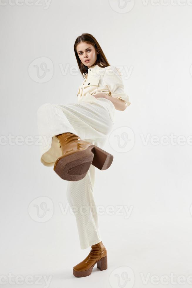 portrait of woman in boots white suit glamor isolated background photo